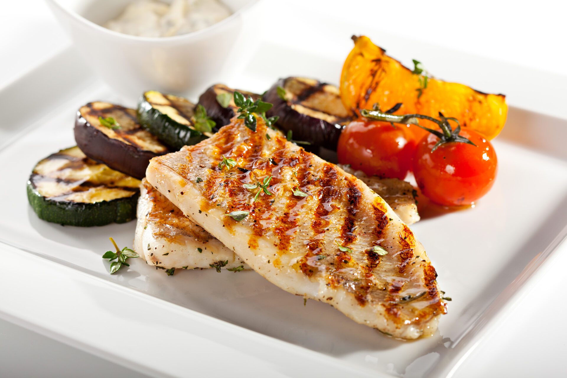 Grilled,Fish,Fillet,With,Bbq,Vegetables A woman and her doctor converse on a couch, highlighting a moment of medical consultation and care.